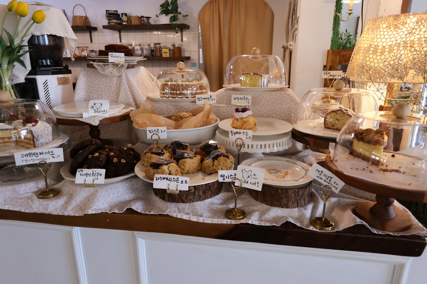 Assorted cakes and pastries sit on display in a cafe.